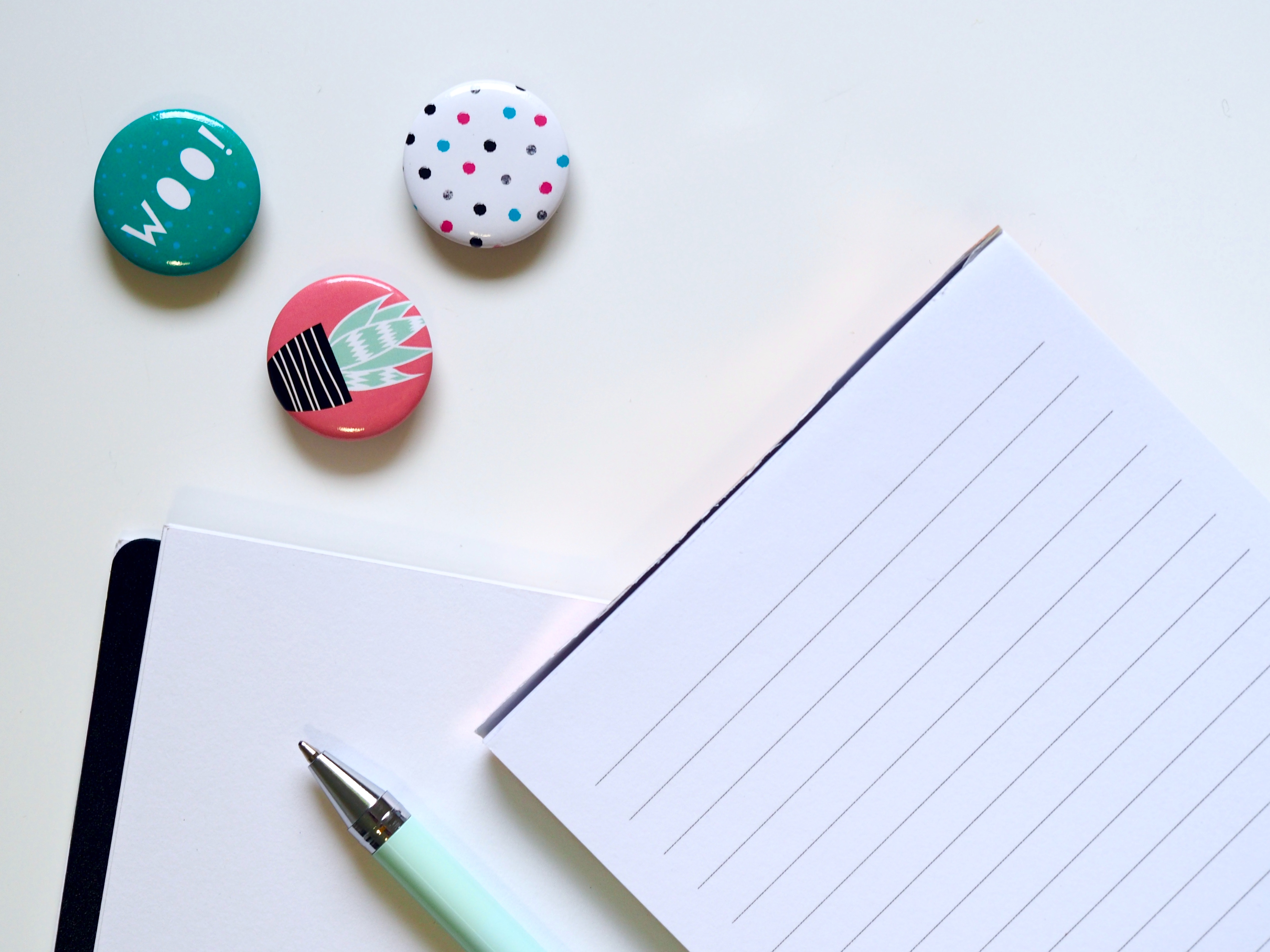 Header image for the article displaying a notebook, pen and cute pins.