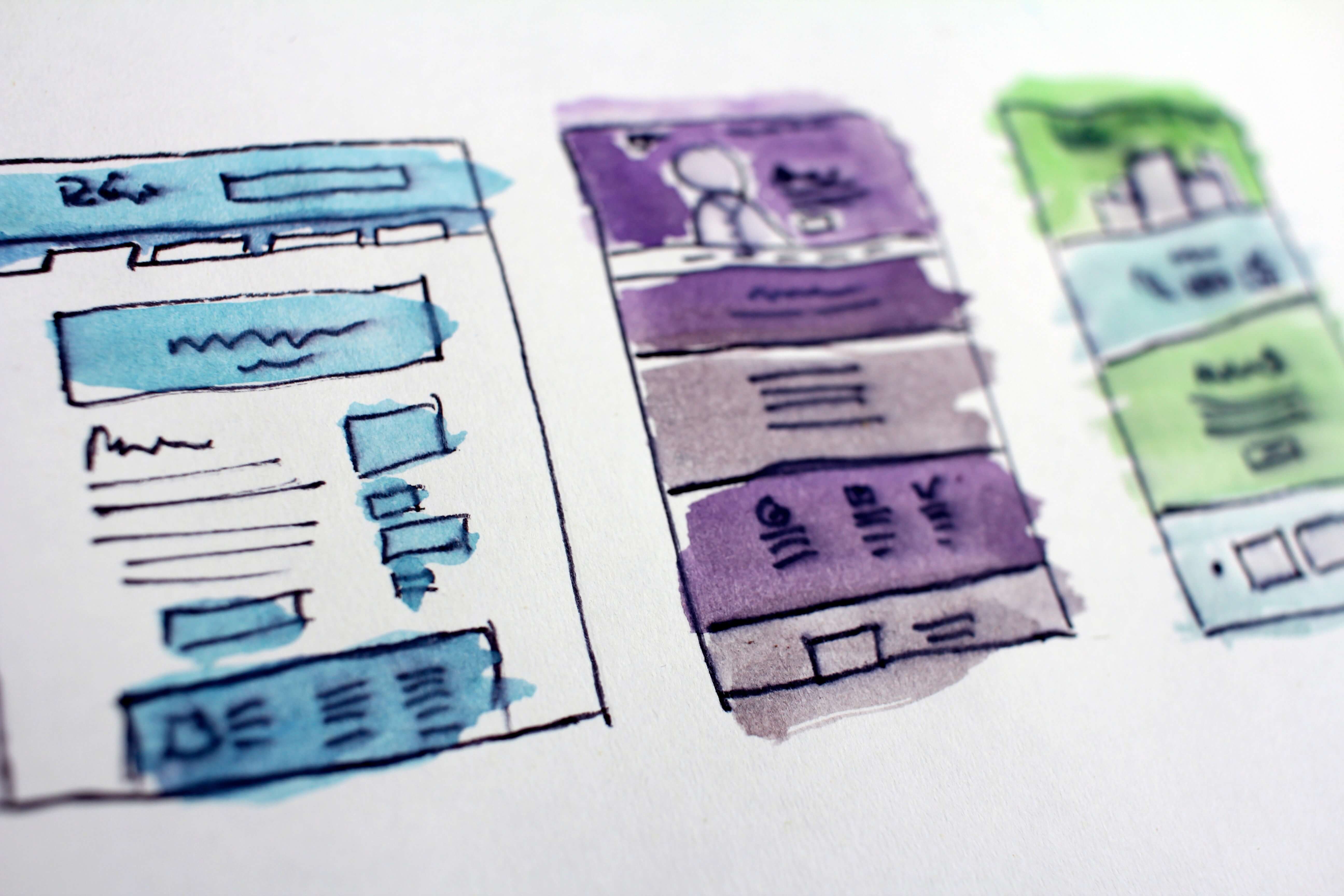 A piece of paper with colorful website sketches.